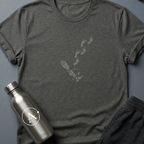 Walking on One Leg sci-fi t-shirt — a robot leg left behind, human footprints continuing on without it — Dark Heather unisex tee — Apsion Outpost