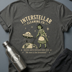Better Homes and Galaxies sci-fi t-shirt — a 1950s alien housewife with a UFO vacuum beaming up humans from Earth — Dark Heather unisex tee — Apsion Outpost